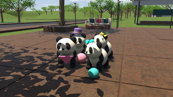 Four pandas gathered around pink and teal balls on the town-square paving